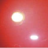 Image showing reflection of strong light source in a surface with low haze