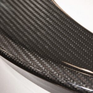 Detail of a carbon fiber molded element, with close up of the textured surface and pattern of the high technology material.